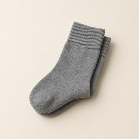 A folded pair of plain gray cotton socks